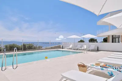 a swimming pool with a view of the ocean at Résidence Eden Suites in Ajaccio