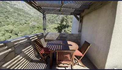 a patio with a table and chairs on a balcony at L'Olivella in Lama