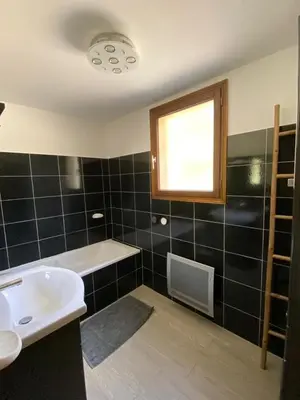 a bathroom with a sink and a tub and a window at L'Olivella in Lama