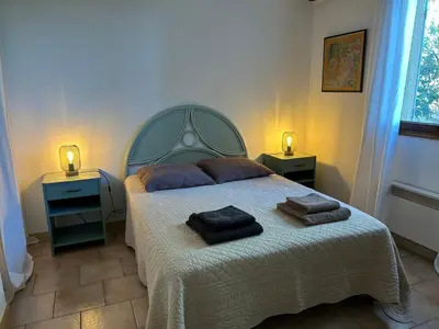 a bedroom with a bed with two towels on it at L'Olivella in Lama