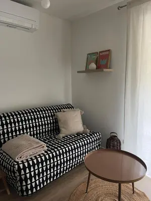 a living room with a black and white couch and a table at Casa PANGRANI in Ajaccio
