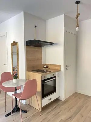 a kitchen with a table and a sink and a stove at Casa PANGRANI in Ajaccio
