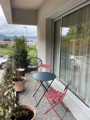 a patio with two chairs and a table on a balcony at Casa PANGRANI in Ajaccio