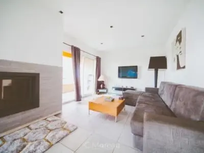 a living room with a couch and a coffee table at Casa Ghjuvanna in Propriano