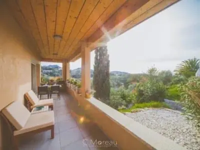 a balcony of a house with a table and chairs at Casa Ghjuvanna in Propriano