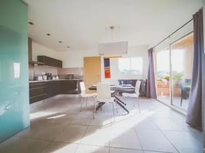 a kitchen with a table and chairs in a room at Casa Ghjuvanna in Propriano