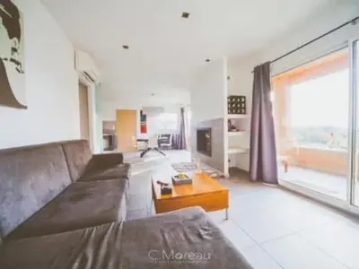 a living room with a couch and a coffee table at Casa Ghjuvanna in Propriano