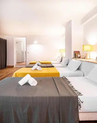 a group of three beds in a room at La tonnelerie, belle villa pour 9 personnes au coeur d'un vignoble avec piscine in Sartène
