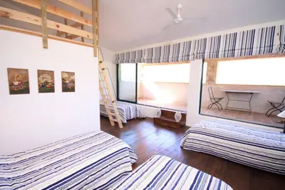 a bedroom with two bunk beds and a ladder at Les anciennes écuries, belle villa pour 12 personnes au coeur d'un vignoble avec piscine in Sartène