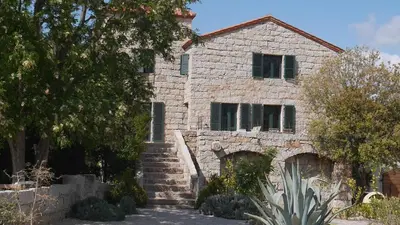 an old stone house with stairs in front of it at Le chai, belle villa pour 13 personnes au coeur d'un vignoble avec piscine in Sartène