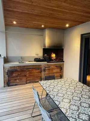 a kitchen with a table and chairs in a room at Villa Mare piscine et spa in Zonza