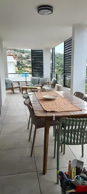 a dining room with a wooden table and chairs at Appartement 4 pers en résidence in Propriano