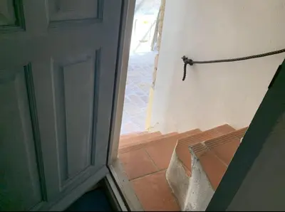 an open door to a room with a stairway at Appartement citadelle Bonifacio Appolonie in Bonifacio