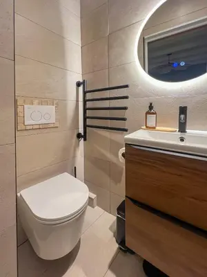 a bathroom with a toilet and a sink and a mirror at Appartement citadelle Bonifacio Appolonie in Bonifacio