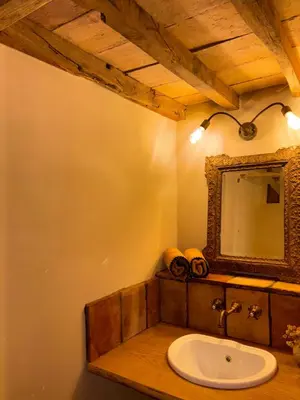 a bathroom with a sink and a mirror at Bergerie CASEDDU U CHJASSU in Viggianello