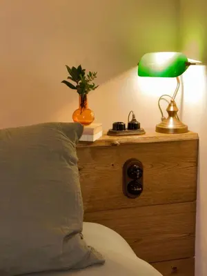 a bedroom with a bed with a lamp and a pillow at Bergerie CASEDDU U CHJASSU in Viggianello