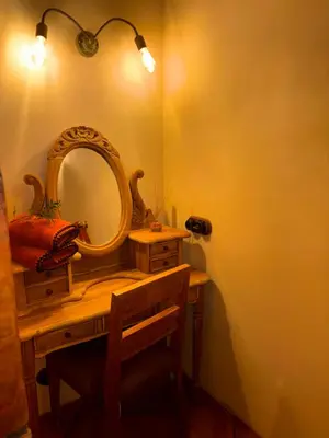 a bathroom with a mirror on a wooden table at Bergerie CASEDDU U CHJASSU in Viggianello