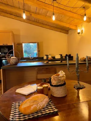 a kitchen with a table with some bread on it at Bergerie CASEDDU U CHJASSU in Viggianello
