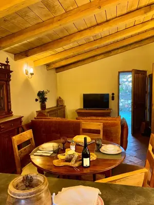 a living room with a table and a couch at Bergerie CASEDDU U CHJASSU in Viggianello