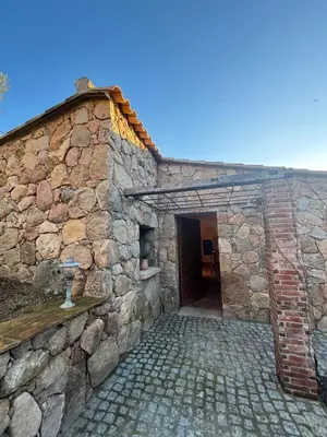 an external view of a stone building with a doorway at Bergerie CASEDDU U CHJASSU in Viggianello
