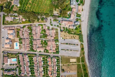 an aerial view of a resort complex next to the ocean at Résidence hôtelière D'Amare in Cervione