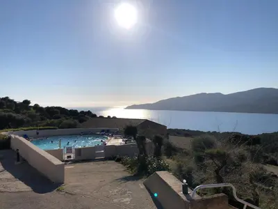 a swimming pool with a view of a body of water at Alba rossa in Serra-di-Ferro
