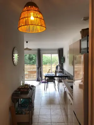 a kitchen with a table and a large light fixture at Alba rossa in Serra-di-Ferro