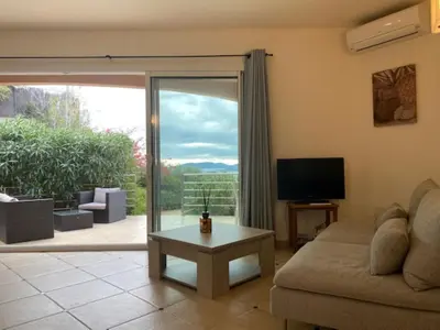 a living room with a couch and a tv at Villa eden blue F4 3 in Zonza