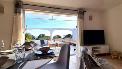 a dining room with a table and a large window at Appartement Ruscana, 4 pers, 90 m plage in Pinarellu