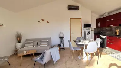 a living room with a couch and a table and chairs at Appartement Ruscana, 4 pers, 90 m plage in Pinarellu