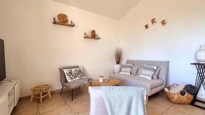 a living room with a couch and a table at Appartement Ruscana, 4 pers, 90 m plage in Pinarellu