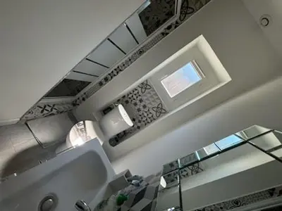 a bathroom with a sink and a window and a mirror at Straboni corte in Corte
