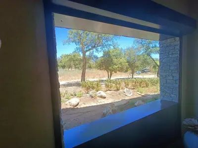 a table with chairs and a couch with a mirror at Appt neuf 2-4 pers avec loggia - Piscine chauffée - Bord de mer - Corse du Sud- Bonifacio in Pianottoli-Caldarello
