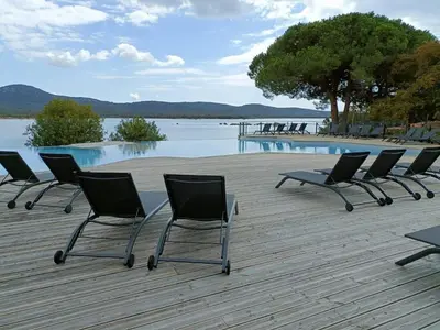 a window in a room with a view of a field at Appt neuf 2-4 pers avec loggia - Piscine chauffée - Bord de mer - Corse du Sud- Bonifacio in Pianottoli-Caldarello