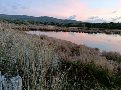 a sunset over a body of water at Appt neuf 2-4 pers avec loggia - Piscine chauffée - Bord de mer - Corse du Sud- Bonifacio in Pianottoli-Caldarello