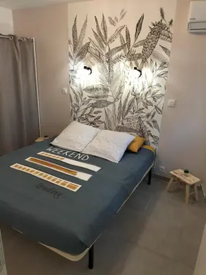 a bed in a room with a mural on the wall at incore di u maquis corsu in Sotta