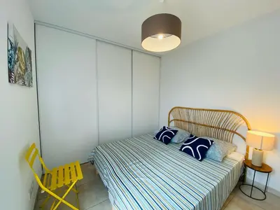 a bedroom with a bed with blue and white pillows at BONIFACIO Villa U ARANCIU in Bonifacio