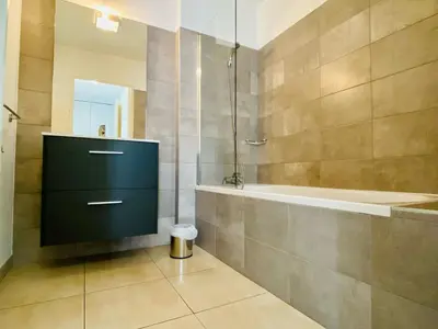 a bathroom with a shower and a sink and a tub at BONIFACIO Villa U ARANCIU in Bonifacio