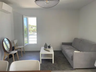 a living room with a couch and a table at Appartement Solaro, plage à 100m in Solaro