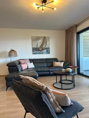a living room with a couch and a table at Torriciola location Genovese in Ajaccio