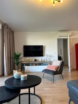 a living room with a couch and a table at Torriciola location Genovese in Ajaccio