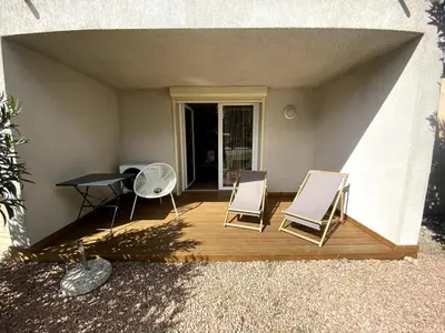 a patio with two chairs and a table and a table and chairs at Studio Corse entre mer et maquis cala rossa in Lecci