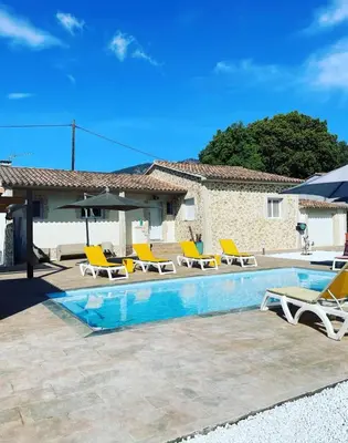 a villa with a swimming pool and lounge chairs at Villa Jessy Porto-Vecchio in Porto-Vecchio