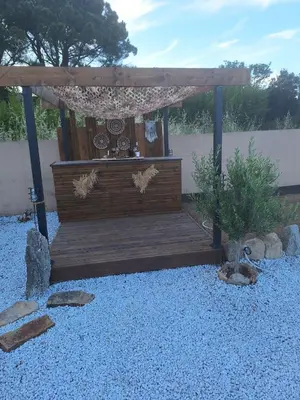 a wooden pergola in a yard with at Villa Jessy Porto-Vecchio in Porto-Vecchio