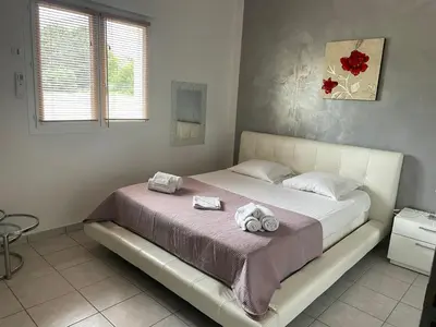 a bedroom with a bed with two towels on it at Villa Jessy Porto-Vecchio in Porto-Vecchio