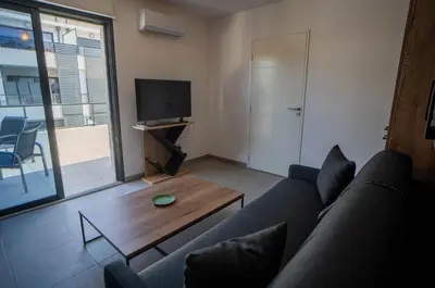 a living room with a couch and a coffee table at Studio moderne et lumineux, proche centre ville in Propriano