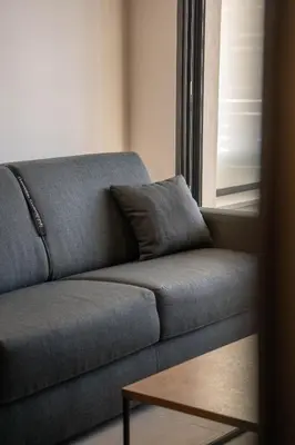 a living room with a couch and a coffee table at Charmant T2 proche centre ville et terrasse in Propriano