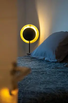 a bedroom with a bed with a pillow and a lamp at Charmant T2 proche centre ville et terrasse in Propriano
