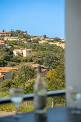 a view of a city from a window at Charmant T2 proche centre ville et terrasse in Propriano