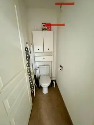 a bathroom with a white toilet in a room at Appart résidence avec piscine in Propriano
